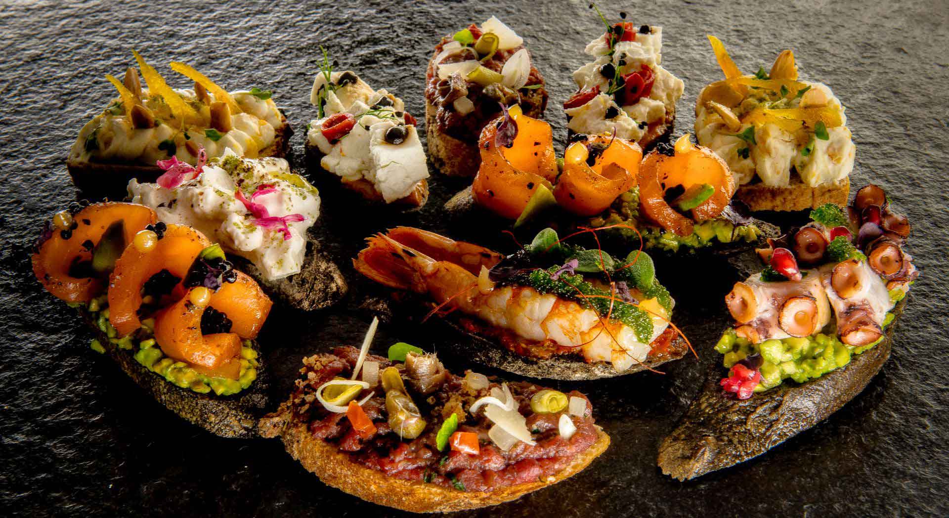 Catering und Feinkost — Auswahl an Fingerfood auf Schieferplatte